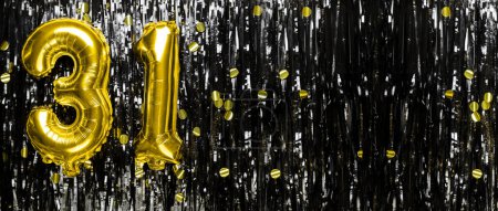 Photo for Gold foil balloon number number 31 on a background of black tinsel decoration. Birthday greeting card, inscription thirty one. Anniversary event. Banner. copy space. - Royalty Free Image