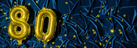 Photo for Golden foil balloon number eighty. Birthday or anniversary card with the inscription 80. blue velvet background. Anniversary celebration. Banner. copy space - Royalty Free Image