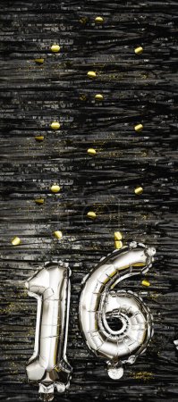 Silver foil balloon number 16 on a background of black tinsel decoration with golden confetti. Birthday greeting card, inscription sixteen. Anniversary event. Vertical Banner. copy space.