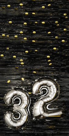 Silver foil balloon number 32 on a background of black tinsel with gold confetti. Birthday card, inscription thirty-second. Anniversary event. Vertical banner.