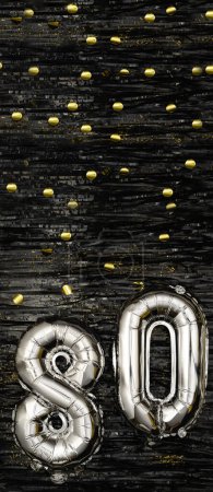 Photo for Silver foil balloon number eighty. Birthday or anniversary card with the inscription 80. Black tinsel background. Anniversary celebration. Vertical Banner. copy space - Royalty Free Image