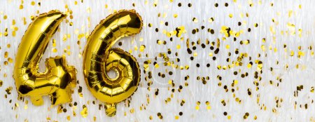 Golden foil balloon number, figure forty-six on white with confetti background. 46th birthday card. Anniversary concept. birthday, new year celebration. banner, copy space.