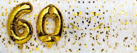 Golden foil balloon number, figure sixty on white with confetti background. 60th birthday card. Anniversary concept. birthday, new year celebration. banner, copy space.