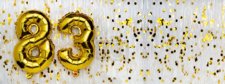 Gold foil balloon number, digit eighty-three. Birthday greeting card with inscription 83. Anniversary celebration. Banner. Golden numeral, white background. Numerical digit. Copy space