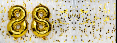 Gold foil balloon number, digit eighty-eight. Birthday greeting card with inscription 88. Anniversary celebration. Banner. Golden numeral, white background. Numerical digit. Copy space