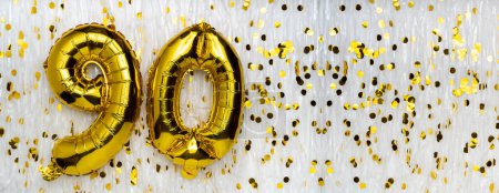 Gold foil balloon number, digit ninety. Birthday greeting card with inscription 90. Anniversary celebration. Banner. Golden numeral, white background. Numerical digit. Copy space