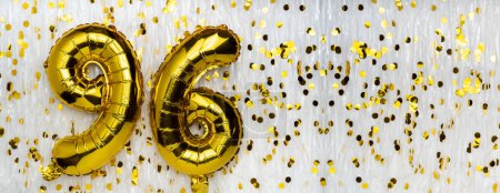 Gold foil balloon number, digit ninety-six. Birthday greeting card with inscription 96. Anniversary celebration. Banner. Golden numeral, white background. Numerical digit. Copy space