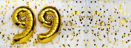 Gold foil balloon number, digit ninety-nine. Birthday greeting card with inscription 99. Anniversary celebration. Banner. Golden numeral, white background. Numerical digit. Copy space
