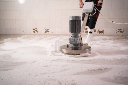 Worker washing long carpet chemical cleaning with professionally disk machine, close-up. Regular clean-up concept.