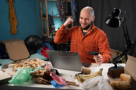 Photo for Happy lucky man freelancer feeling excited winner using laptop computer winning online, getting new job celebrating success. People working in messy room. Copy space - Royalty Free Image