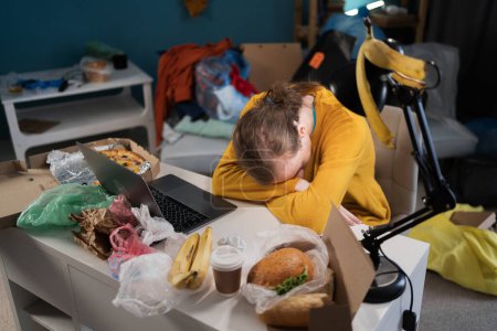 Photo for Tired student sleeping while preparing for exams in dirty, messy room. Copy space - Royalty Free Image