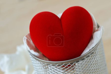 Photo for Close-up of heart in trash basket - Concept of love and suffering - Royalty Free Image
