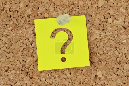 Photo for Post it note with question mark on notice board - Concept of questions, mystery and finding information - Royalty Free Image