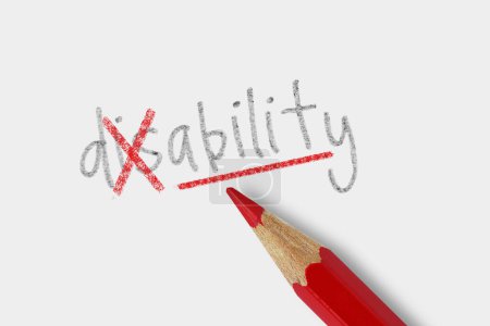 Photo for The word disable corrected with red pencil on white background - Concept of trasforming disability into ability - Royalty Free Image