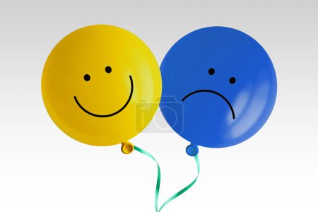 Photo for Happy and sad balloon tied together on white background - Concept of bipolar disorder - Royalty Free Image
