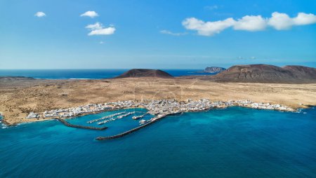 Photo for Panoramic view, aerial shot of La Graciosa, volcanic island surrounded by the Atlantic Ocean, photo taken from Lanzarote Island, Canary Islands of Spain. Travel destinations and tourism concept - Royalty Free Image