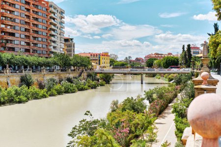 Photo for View to the Miguel Caballero concrete footbridge across Segura River in the center of Murcia city at sunny summer day against architecture and blue cloudy sky background. Spai - Royalty Free Image