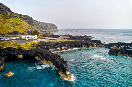 Photo for Aerial shot, drone point of view picturesque nature of Azores, volcanic island of Ponta Delgada. Atlantic Ocean view and cliffs at sunny day. Sao Miguel, Azores, Portugal - Royalty Free Image