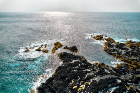Photo for Aerial shot, drone point of view picturesque nature of Azores, volcanic island of Ponta Delgada. Atlantic Ocean view and cliffs at sunny day. Sao Miguel, Azores, Portugal - Royalty Free Image