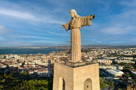 Photo for The Sanctuary of Christ the King is a Catholic monument and shrine dedicated to the Sacred Heart of Jesus Christ overlooking the city of Lisbon situated in Almada, Portugal - Royalty Free Image