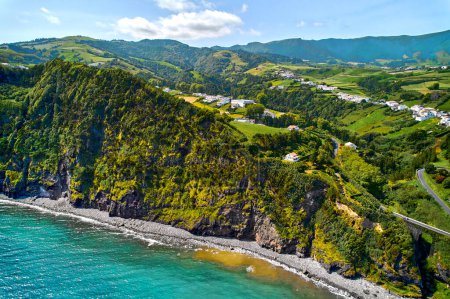 Photo for Aerial shot, drone point of view, picturesque nature of Azores. Green hills and cloudy sky, Atlantic Ocean view during sunny summer day. Sao Miguel, Ponta Delgada island. Portugal - Royalty Free Image