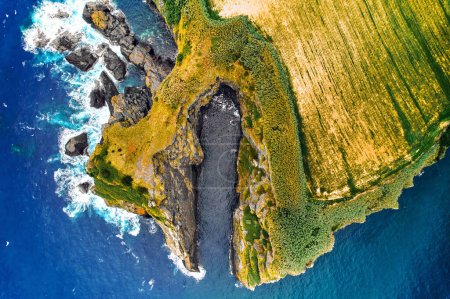 Photo for Aerial shot, drone point of view Atlantic Ocean surf, rocky coastline and farmlands of Ponta Delgada Island. Sao Miguel, Azores, Portugal. Beautiful nature, travel destination, tourist places concept - Royalty Free Image