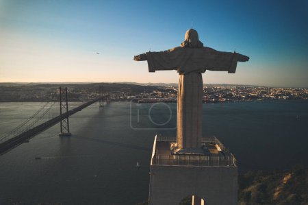 Photo for Aerial view The 25 de Abril Bridge and The Sanctuary of Christ monument. Lisbon - Royalty Free Image