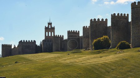 Photo for View to The Walls of Avila historic city, against blue sky during sunny day. Famous fortification, spanish landmark in Castile and Leon. UNESCO. Spain - Royalty Free Image