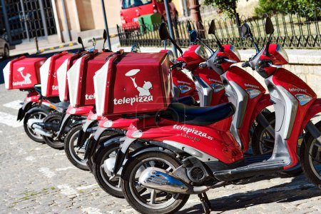 Photo for Delivery motorbikes of Telepizza, a Spanish multinational pizzeria chain with a presence in several countries around the world. Madrid - Royalty Free Image
