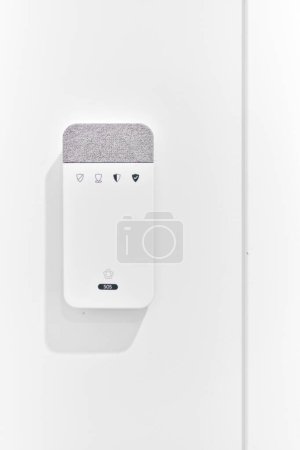 Photo for Close up of contemporary alarm equipment, security panel mounted on wall in modern house against white copy space wall. Security, safety, smart home concept - Royalty Free Image