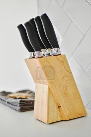 Photo for Close up vertical shot view of wooden knife holder on countertop, no people. - Royalty Free Image