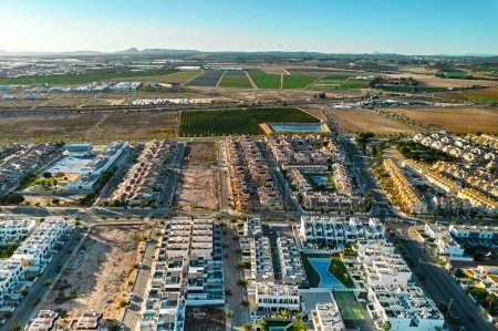 Photo for Torre de la Horadada, view from above. Drone point of view of span ish typical townscape with new-built houses and villas at sunny day. Travel, real-estate, Province of Alicante, Costa Blanca. Spain - Royalty Free Image