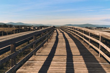 Photo for Empty wooden pedestrian boardwalk leading along famous Beach of the Cathedrals, daytime view of Ribadeo. Destination scenic, travel and tourist places. Northern of Spain, European cities, Galicia - Royalty Free Image