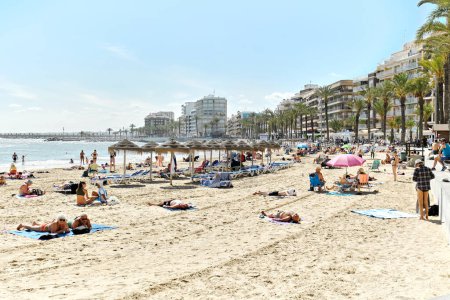 Photo for Torrevieja, Spain - April 19, 2024: Sandy beach of Torrevieja city. Lot of people sunbathing in the Del Cura seaside. Costa Blanca, province of Alicante, Spain. Travel destination and touristic places - Royalty Free Image