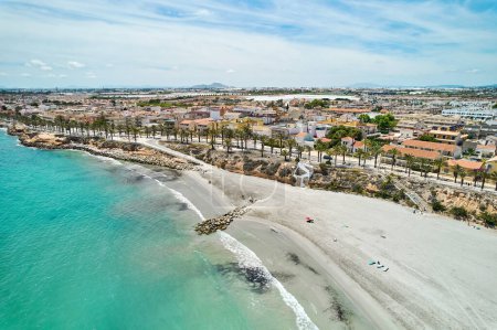 Photo for Aerial shot, drone point of view panoramic image of Torre de la Horadada townscape with beach, bay and city rooftops at sunny summer day. Costa Blanca, Alicante, Spain - Royalty Free Image