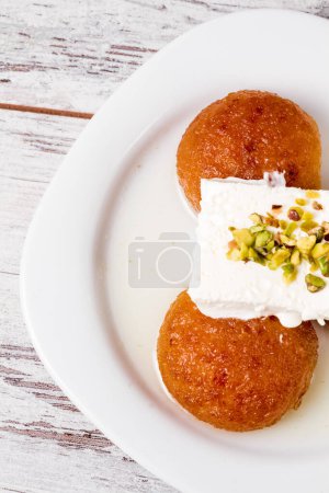 Closeup of delicious kemalpasha, traditional Turkish desserts served on a white plate.