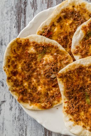 Photo for Lahmacun, home made traditional turkish pizza on wooden white background. - Royalty Free Image