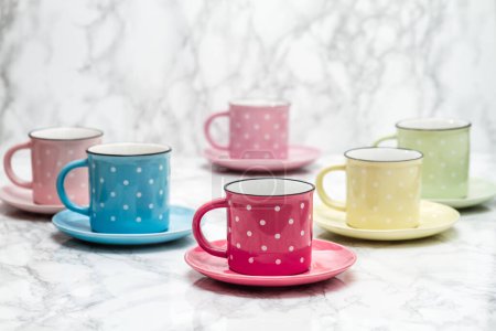 Photo for Colorful ceramic mugs with white dots, artistic arrangement, vibrant colors, unique perspective. - Royalty Free Image
