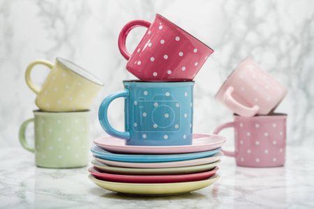 Photo for Stack of multicolored saucers, colorful ceramic mugs, artistic arrangement, unique perspective. - Royalty Free Image