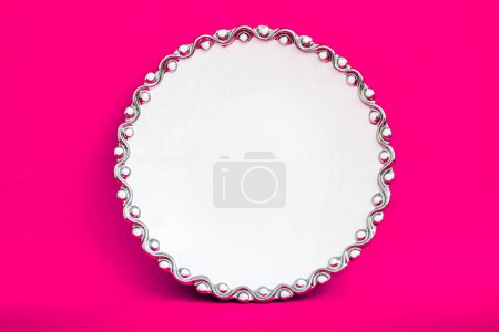 Photo for White porcelain plate on pink background. - Royalty Free Image