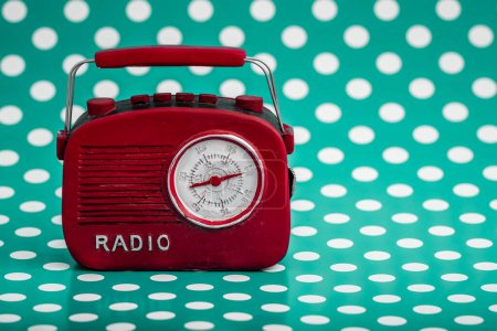 Photo for Red retro style radio with circular dial on green background with white polka dots, generated with AI. - Royalty Free Image