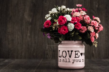 Photo for Lovely bouquet in a modern white flowerpot with text, soft ambiance. - Royalty Free Image
