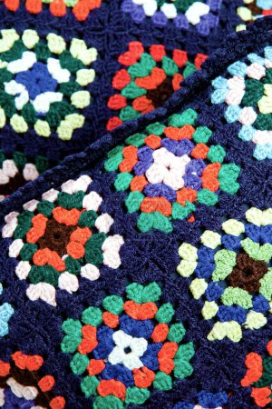 Close up of a colorful knitted textile.