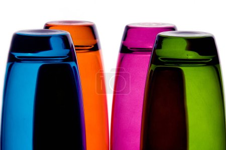 Photo for Glasses in various colors glow and reflect on a surface - Royalty Free Image