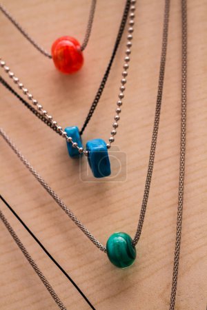 Handcrafted multicolored murano glass necklaces displayed on a light background.