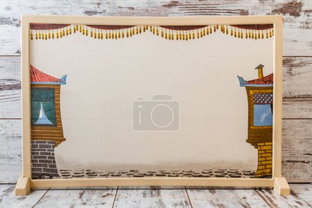 Empty traditional Turkish puppet theater stage with golden curtains