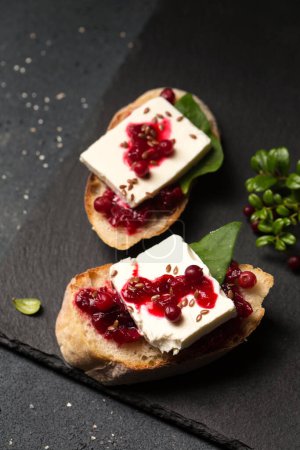 Sandwiches with goat cheese, lingonberry jam and flax seeds