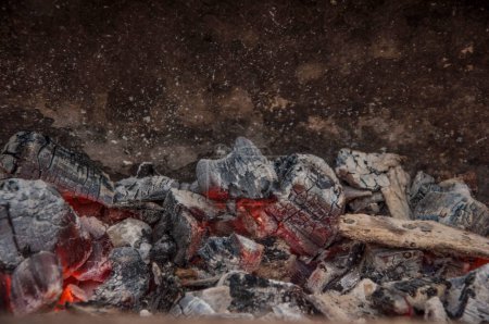 Photo for Burning coals in the dark, smoldering coal. Bright red sparks of fire. Background. - Royalty Free Image