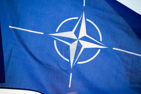 NATO (North Atlantic Treaty Organization) flag waving. NATO is an international military alliance that constitutes a system of collective security