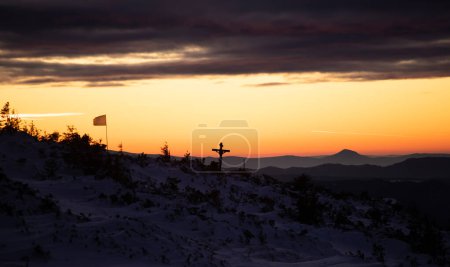 Photo for Christian wooden cross in dramatic lighting, colorful mountain sunset. Easter, resurrection concept. - Royalty Free Image